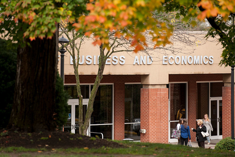 Business and Economics Building framed by fall leaves