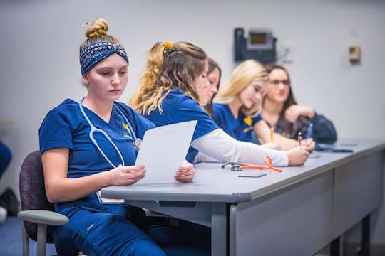 Nursing students reading documents in class