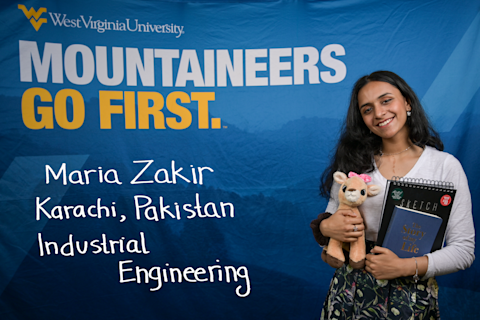 Maria Zakir, an Industrial Engineering major from Karachi, Pakistan, clutches a stuffed animal, sketchbook and a book titled "The Story of My Life."