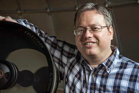 Portrait of Rodney Elliott with telescope
