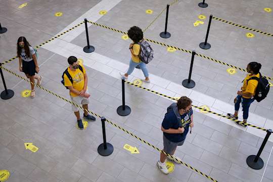 Customers observe physical distancing guidelines in line at the Mountainlair Food Court
