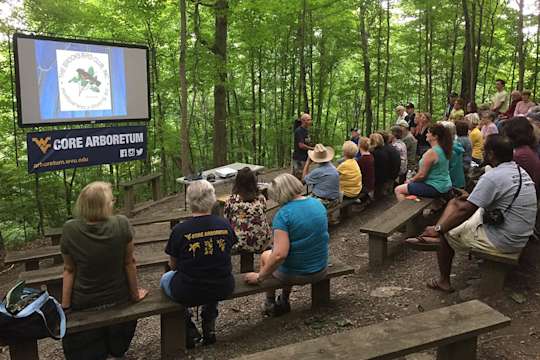 Audience gathers for a presentation at the Core Arboretum amphitheater