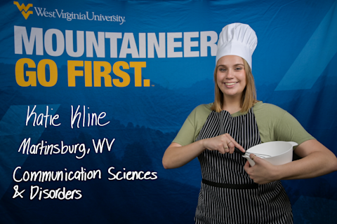 Katie Kline, a Communication Sciences and Disorders major from Martinsburg, WV, wears a chef's hat and stirs a whisk inside a white bowl.