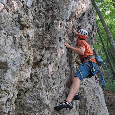Me climbing on a short wall in Kaltenleutgebener Tal