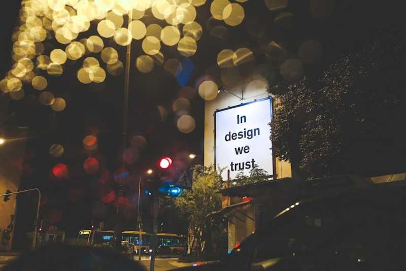 A picture of a sign outside reading "in design we trust"