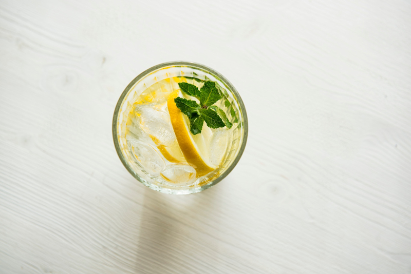 Lemon Water A glass of water with a slice of lemon and mint.