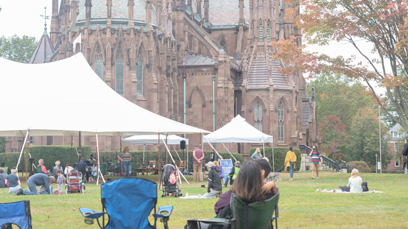 Outdoor worship service with Cathedral in background