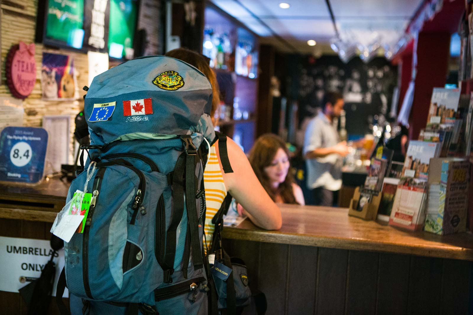 A backpacker checking into the the Flying Pig Uptown hostel.