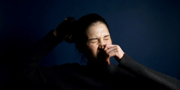 Woman sneezing