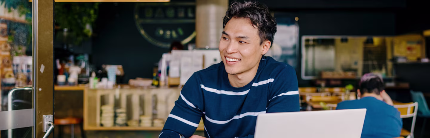 A male IELTS test taker wearing a blue shirt preparing for the test.