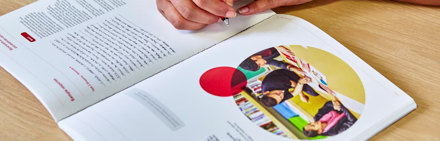 An IELTS test taker preparing for the test using the official IELTS preparation booklet