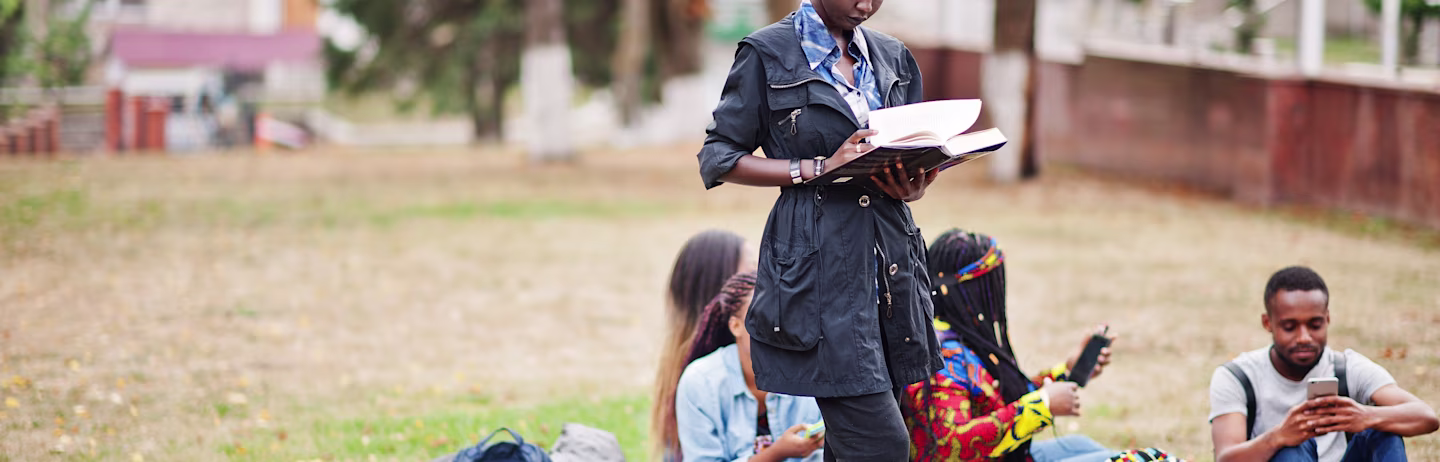 A group of IELTS test takers preparing for IELTS in the lawn of an university