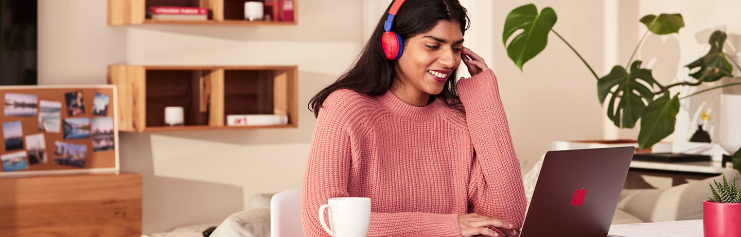 An IELTS test taker listens to an audio clip during a IELTS on computer session.