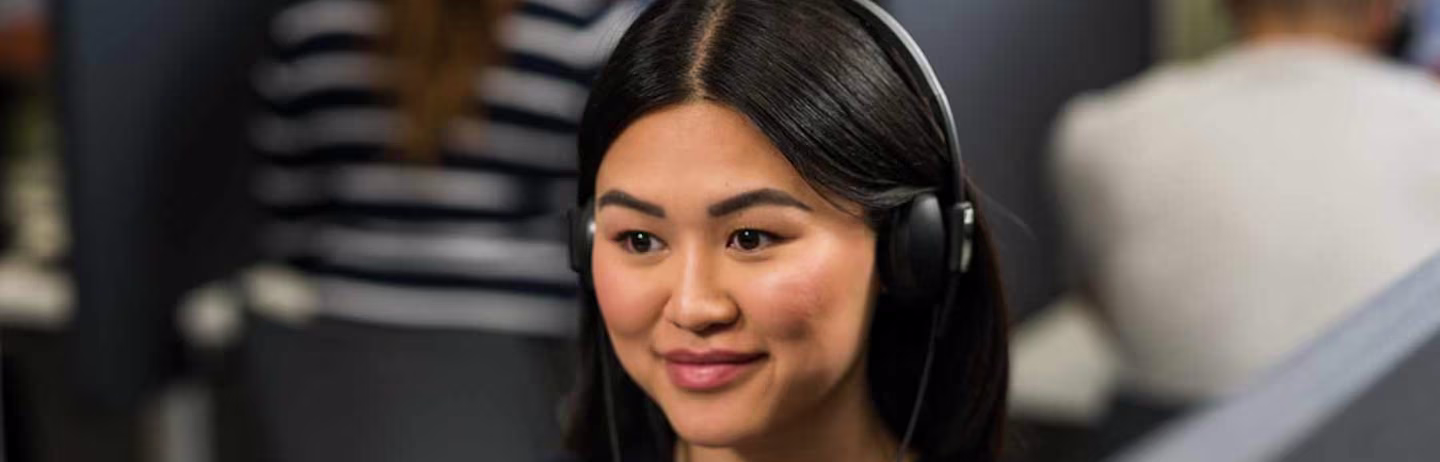Female test taker wearing a black top attends a computer-delivered IELTS test session