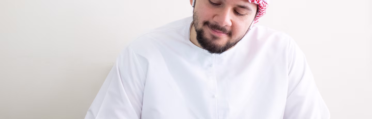 Male IELTS test taker taking notes