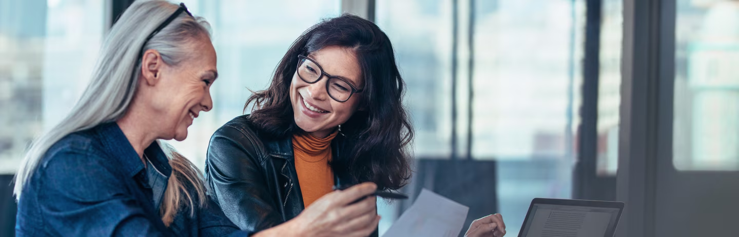 Three students laughing and rejoicing on the street.