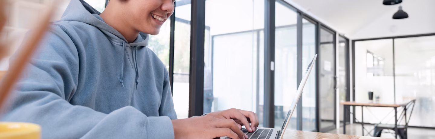 A man taking an IELTS progress check on his computer.