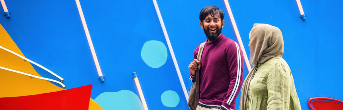 Two test takers talking and walking