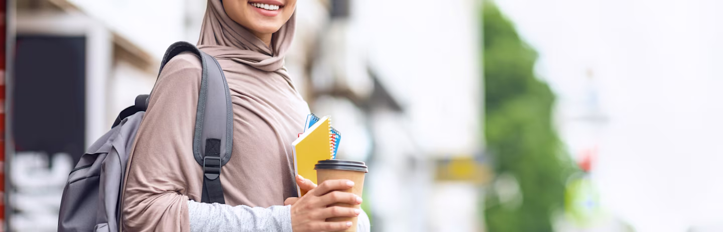 A female test taker holding coffee