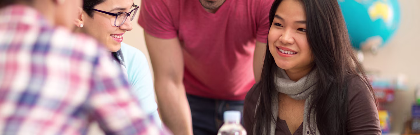 Three female test takers and male test taker in casual attire discuss about IELTS