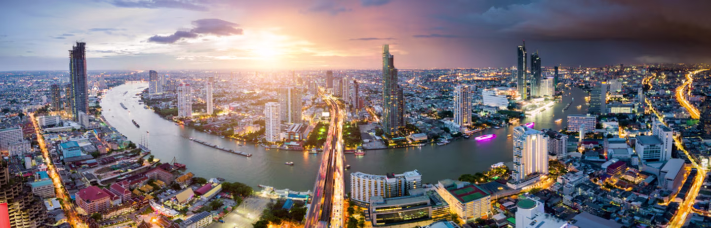 Aerial view of Bangkok skyline and skyscraper with light trails on Sathorn Road center of business in Bangkok downtown.