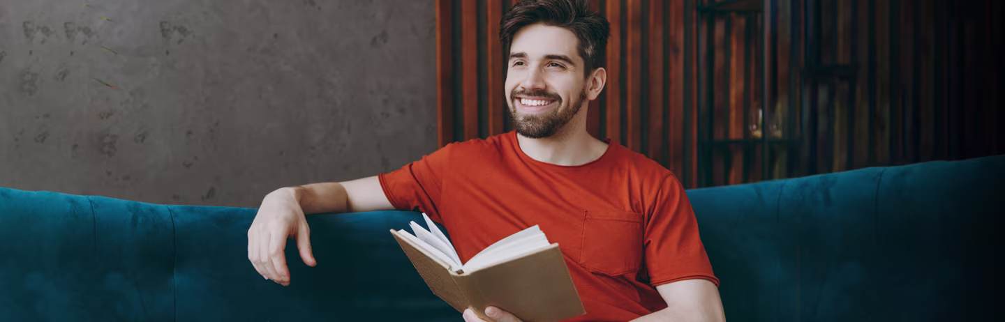 Male IELTS test taker prepares for the test in a library