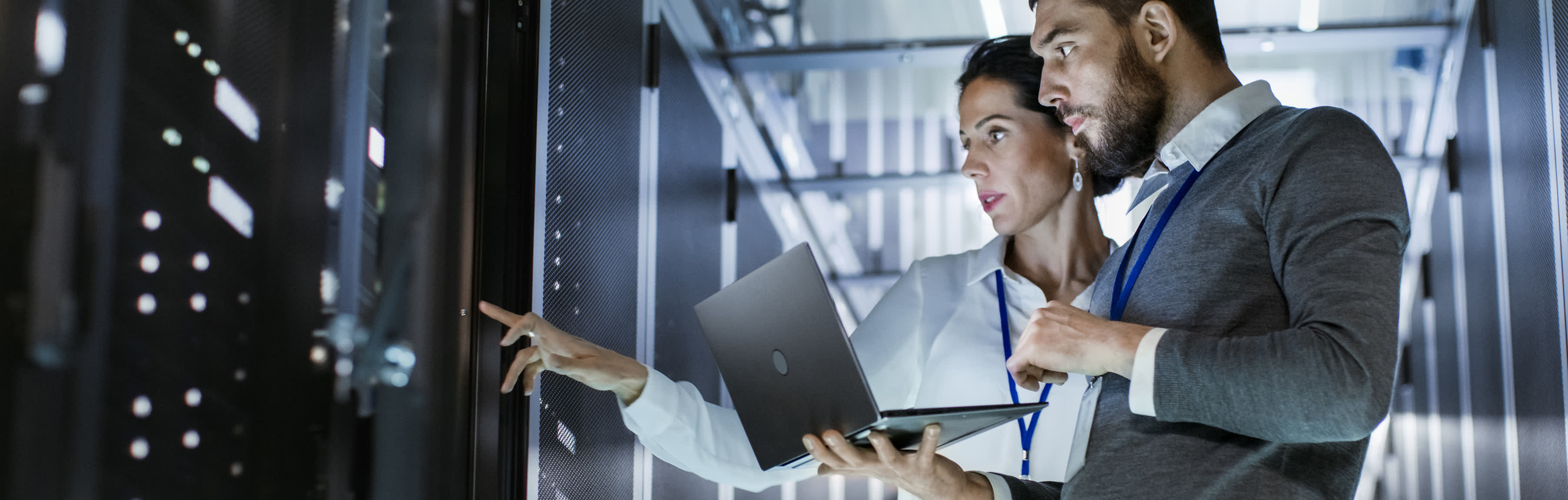 Zwei IT-Techniker beraten sich in einem Serverraum