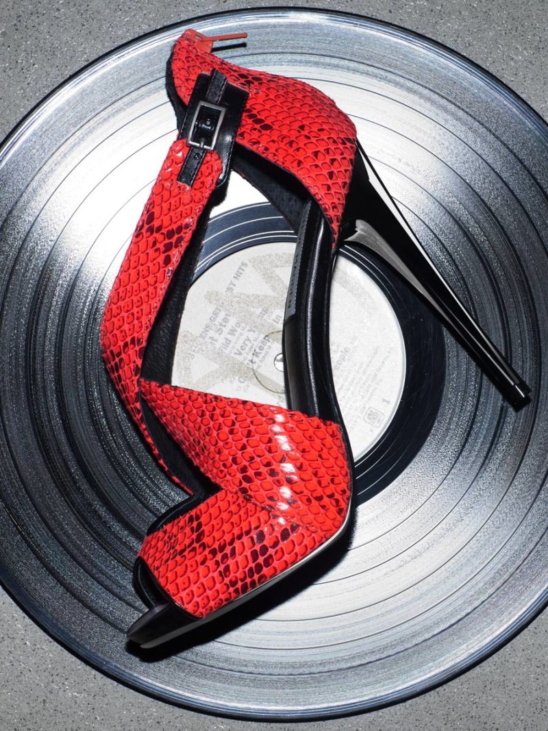 Red leather high heel on a record