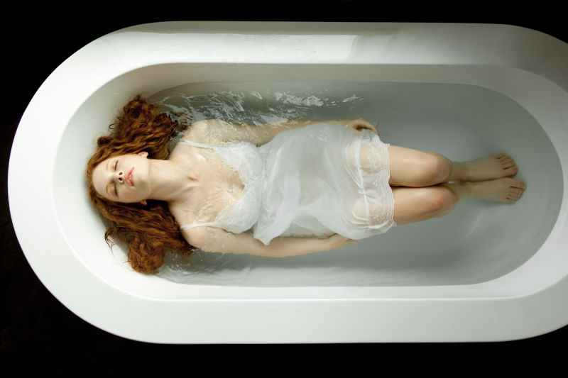 Woman in a dress in bath tub