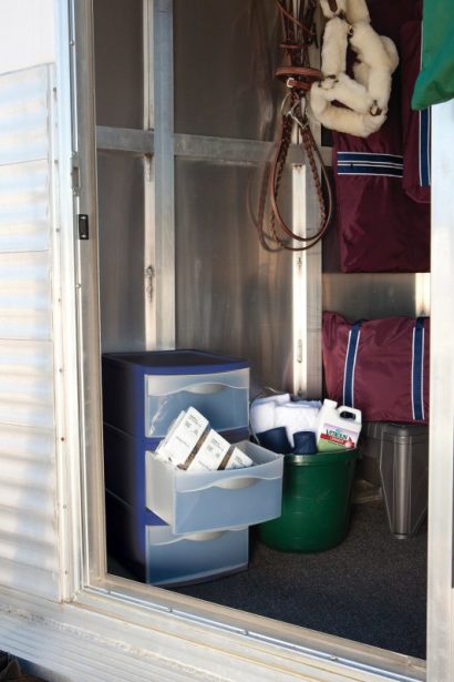 SmartPak supplements organized in a cubby on the horse trailer.