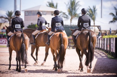 hunter jumper riders walking together at a horse show