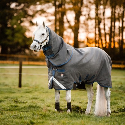 A grey horse wearing the Rhino Plus HexStop Turnout Blanket with Vari-Layer.