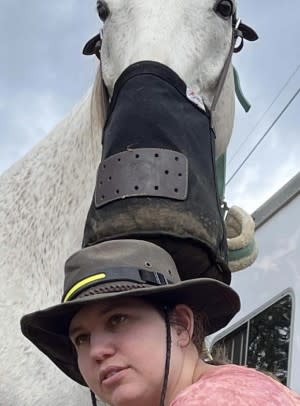selfie of SmartPaker Beth with grey horse and feed bag 
