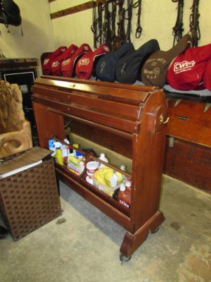 Saddle horse cleaning station with leather cleaning supplies in a tack room.