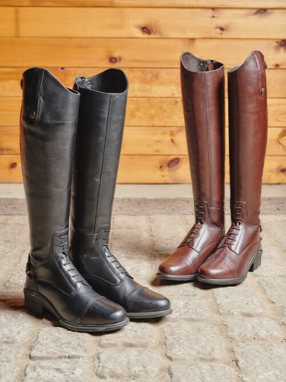 Two pairs of black and brown tall riding boots.