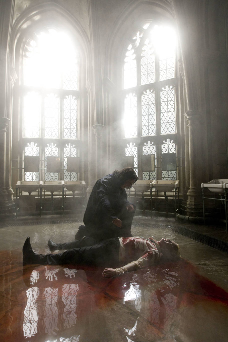 Still of Draco bleeding after being hit by Sectumsempra as Snape uses the counter curse
