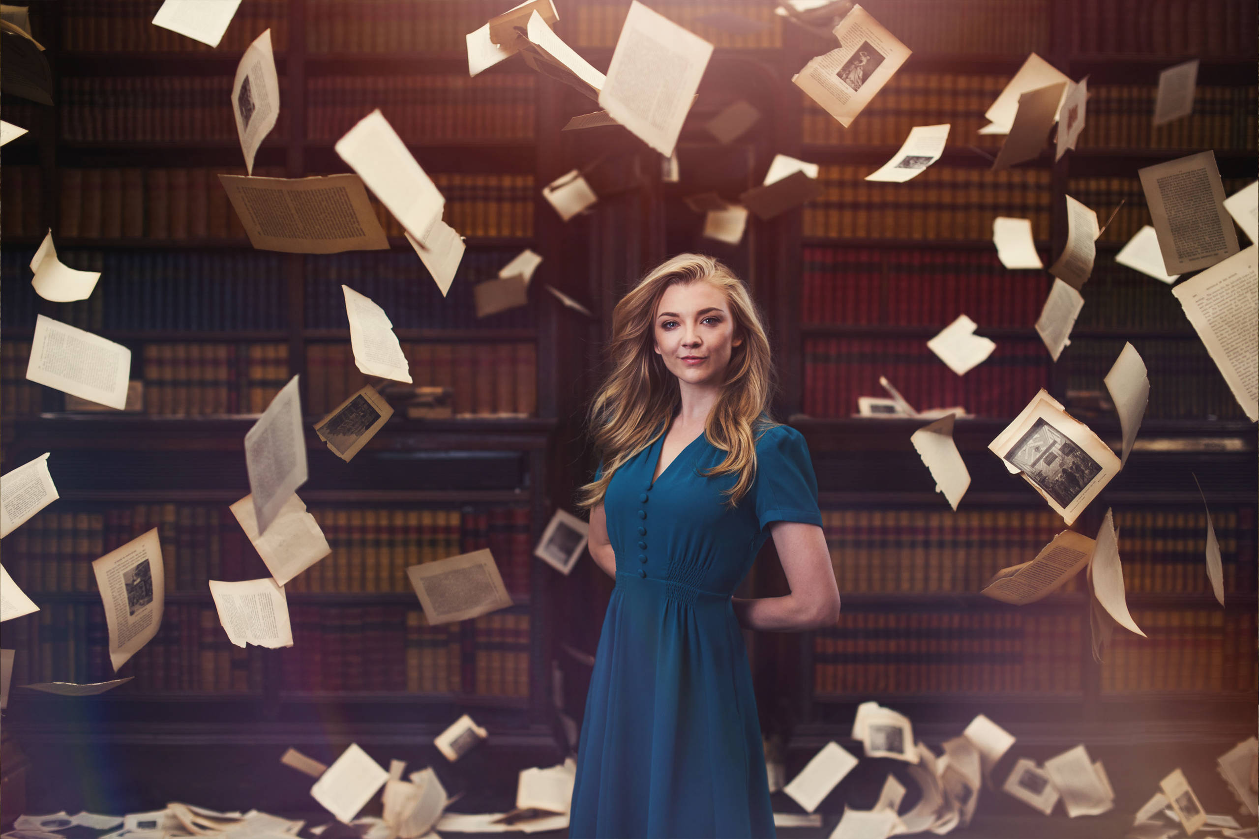 Natalie Dormer surrounded by flying pages from History of Magic book