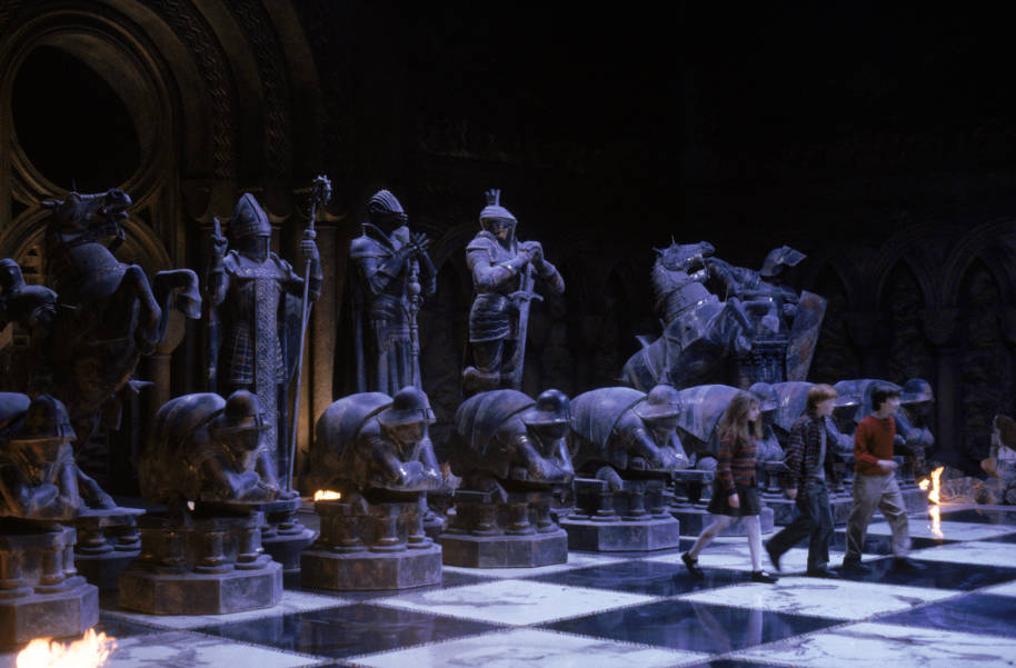 Harry, Ron and Hermione walking across the giant chess board