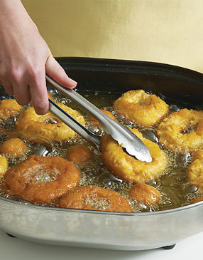 Fry the doughnuts and holes in batches. But keep an eye on the doughnut holes, they won't require as much cooking time.