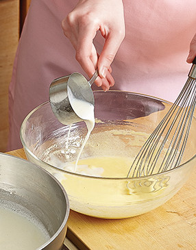 So the yolks don’t curdle, temper them by drizzling the hot milk mixture into them while whisking.