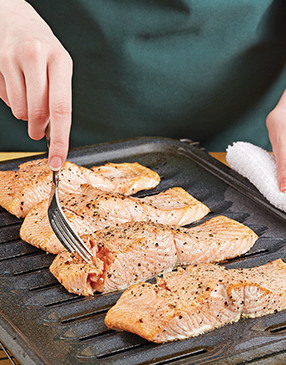 Use a fork to gently test the doneness of the salmon. It’s done when the flesh flakes easily.