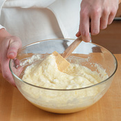 Gently fold the whipped egg whites into the lemon mixture, lifting the batter from bottom to top. 