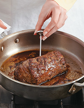 Remove pan from the oven to check the temperature. Keep the handle covered to protect your hands.