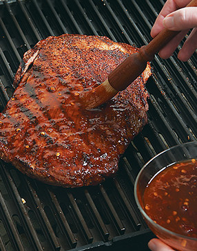 Grill steak on one side, then flip and glaze. Don't glaze before this point or the sauce could burn.