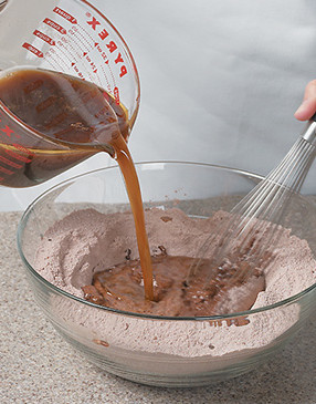 Combine wet ingredients with dry, whisking just to combine. Do not overmix or cake could be tough.