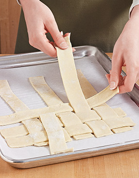 Weave 1-inch-wide strips of puff pastry into a lattice that's the same size as your baking dish.