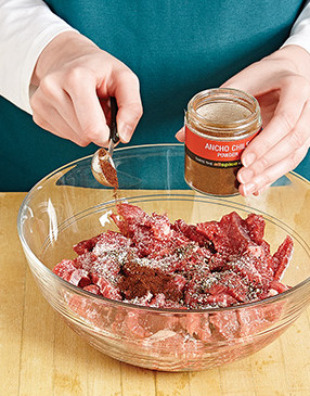 Add the seasonings to the steak mixture, then toss thoroughly to be sure everything is well coated.