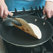 Heat tortillas over high heat on both sides until brown in spots and crisp around the edges. 
