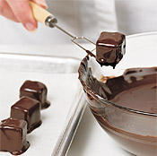 The tips of a dipping fork are flat, making it easier to dip and remove the truffles from the chocolate.