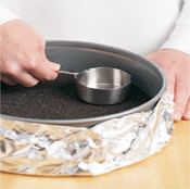 Tamping the crust with a heavy, flat-bottomed object like a glass or measuring cup ensures a firm crust. 